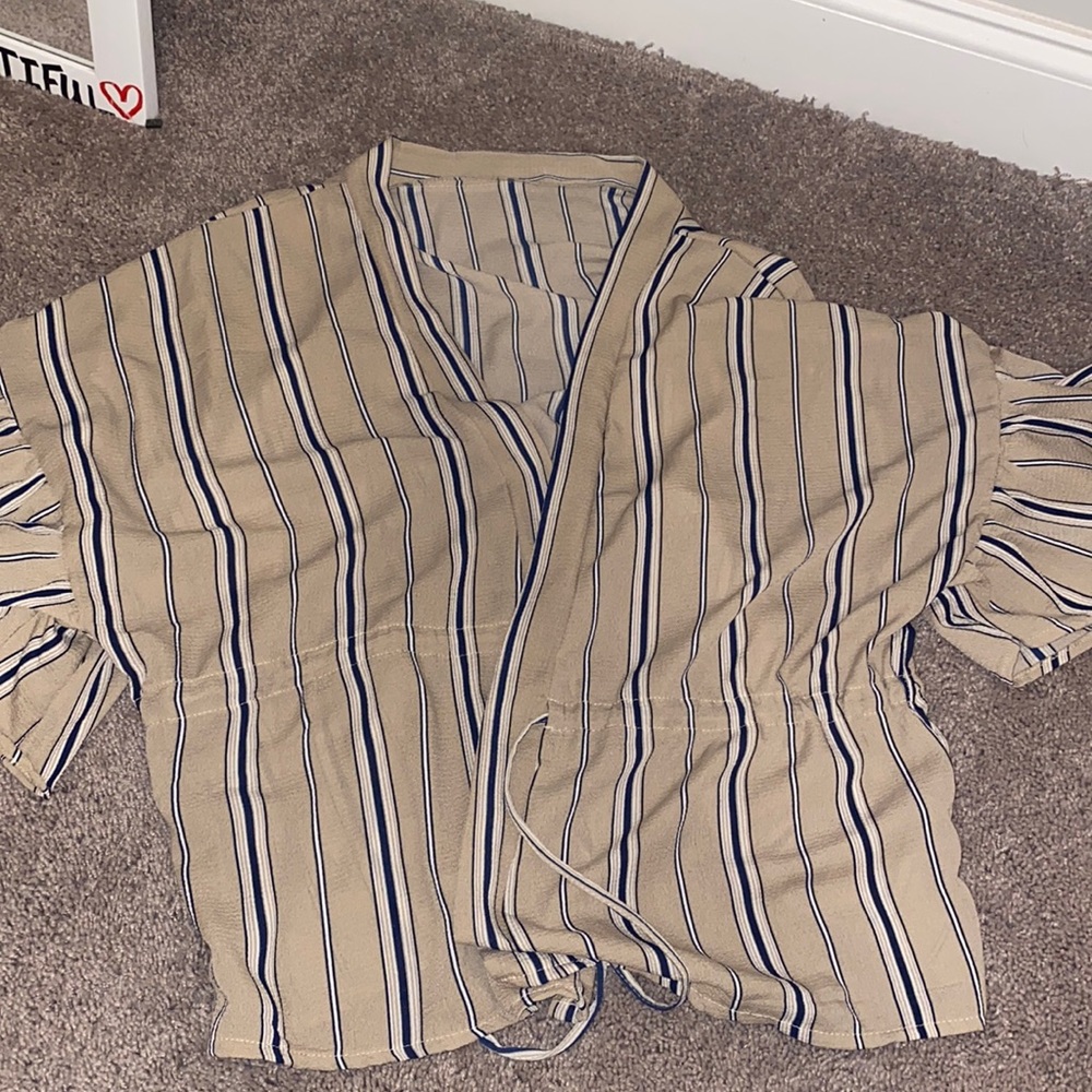 Short sleeve tan shirt with navy stripes.